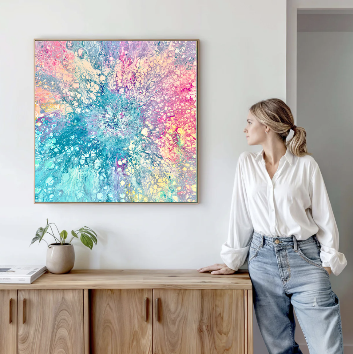 Pink canvas wall art in oak frame.