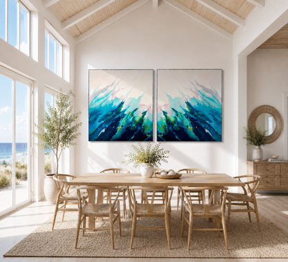 Dining room with a large wooden table and chairs, featuring two abstract blue artworks on the wall.